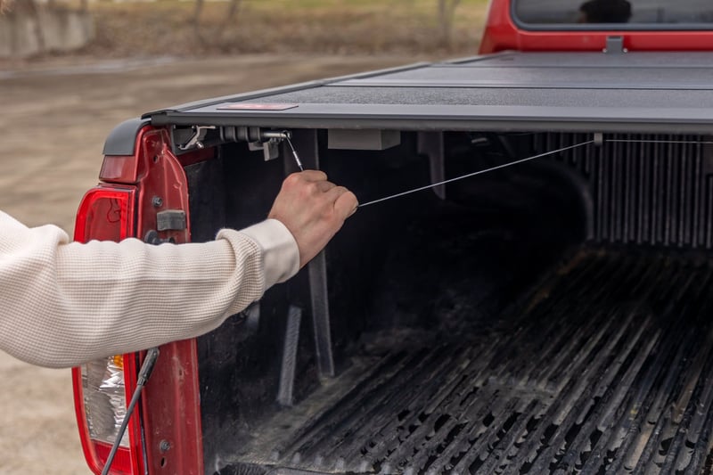RC Hard Low Profile Bed Cover | 5' Bed | Cargo Mgmt | Nissan Frontier (05-21) (manufacturer page)